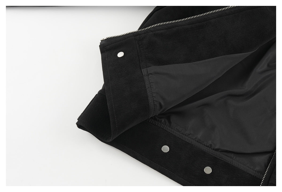 Inside view of the black jacket showing smooth dark lining, zipper teeth, and metal snaps.