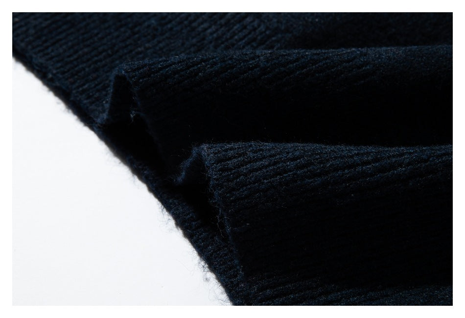 Close-up of a ribbed edge on the dark navy sweater, showing the knit construction.