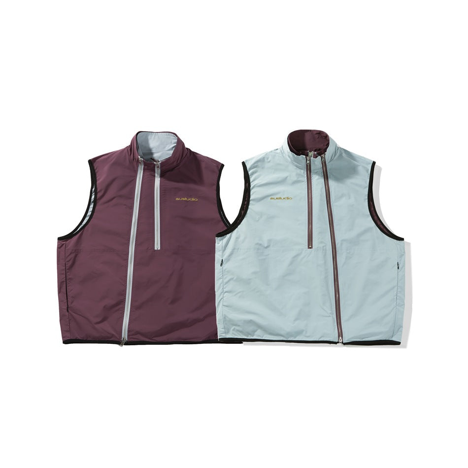 Two sleeveless stand-collar vests side by side, one plum with gray zippers and one pale blue with brown zippers