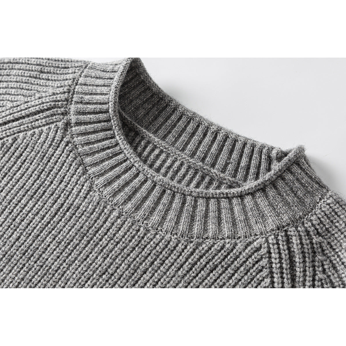 Close-up of a gray rib-knit sweater's crew neckline and shoulder seams.