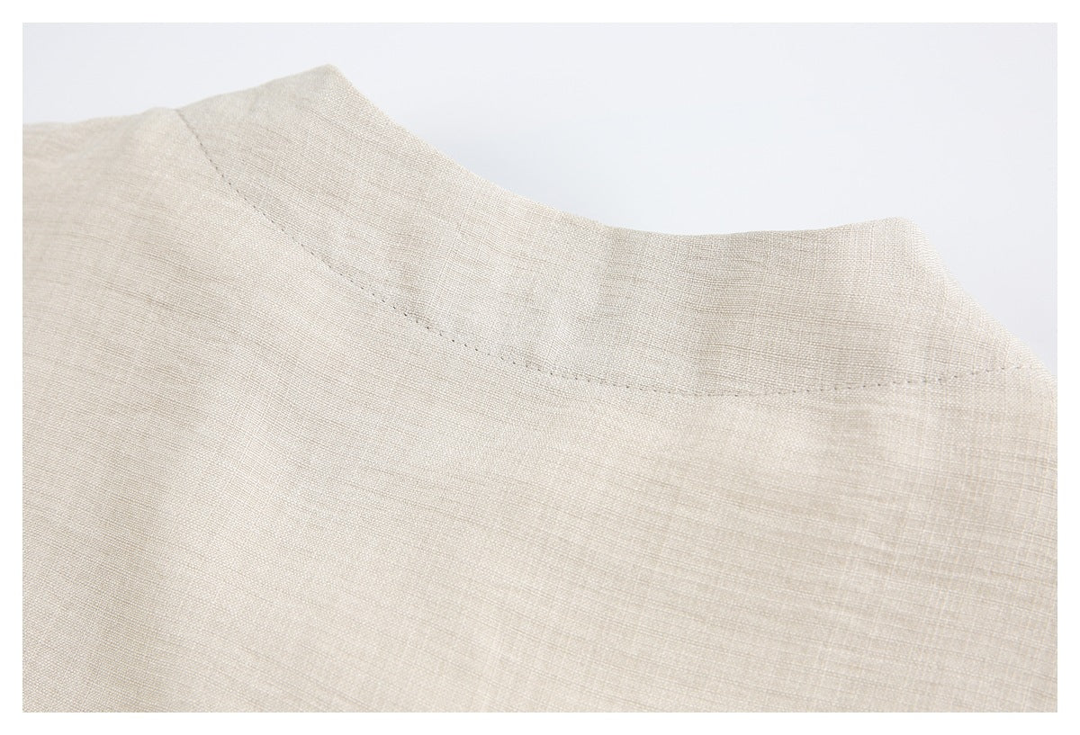 Close-up of the curved stitched collar edge on a beige garment.