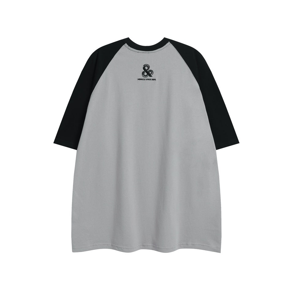 Front view of a gray raglan T-shirt with black sleeves and a small black chest emblem.