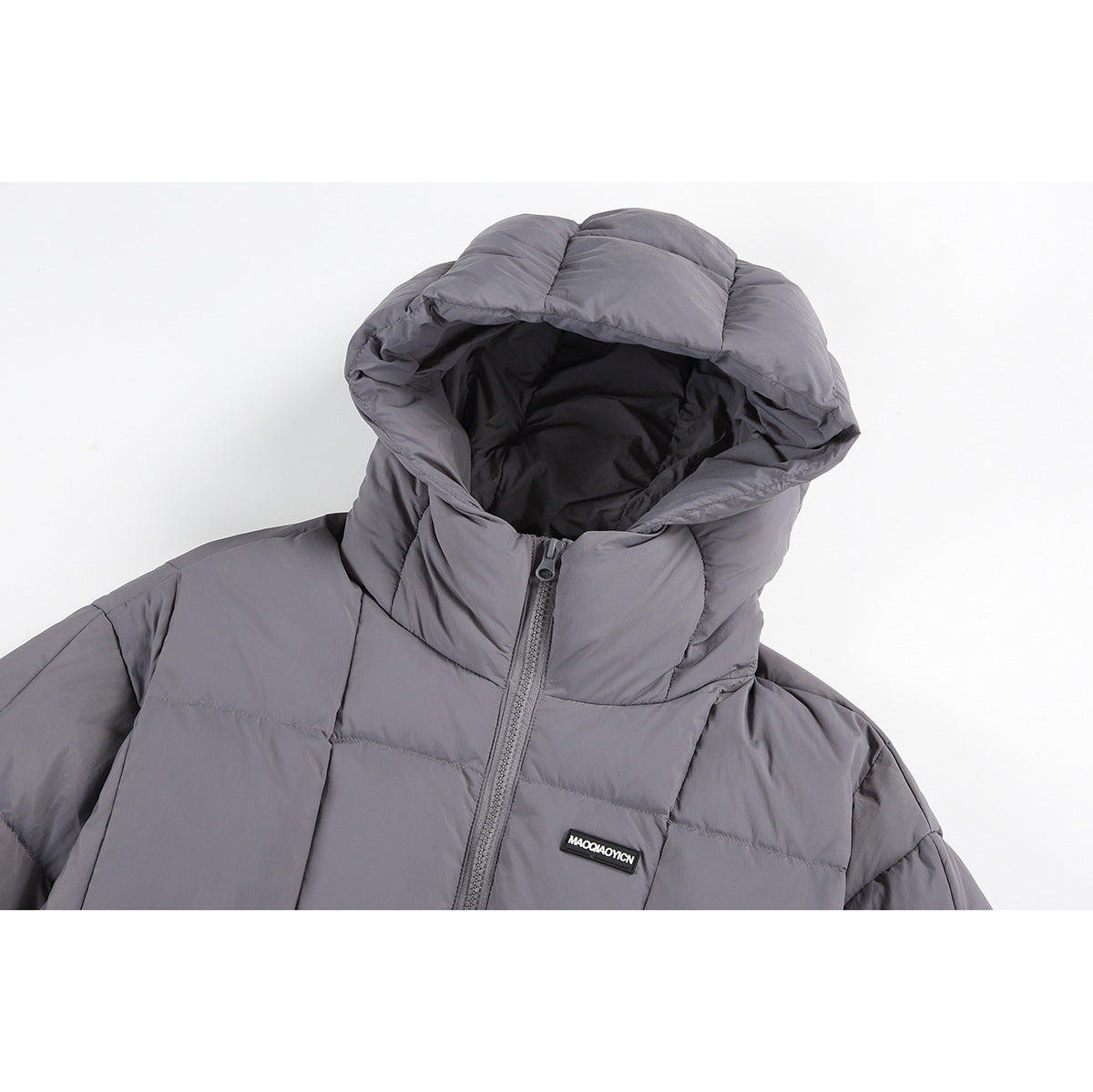 Close-up of a gray padded jacket showing its hood, front zipper, and small black chest label.