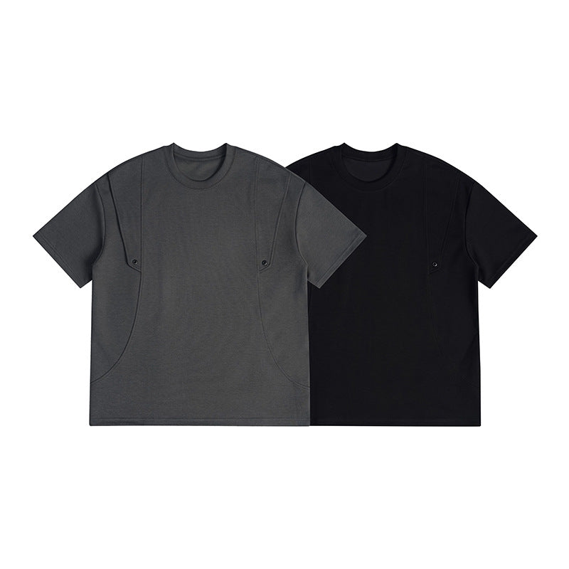 Two short-sleeve crew-neck T-shirts shown from the front in charcoal gray and black, with curved seams and snaps.