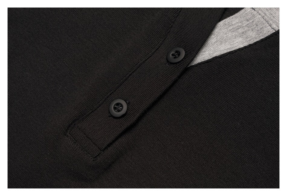 Close-up of a black shirt's two-button placket and gray neckline trim.