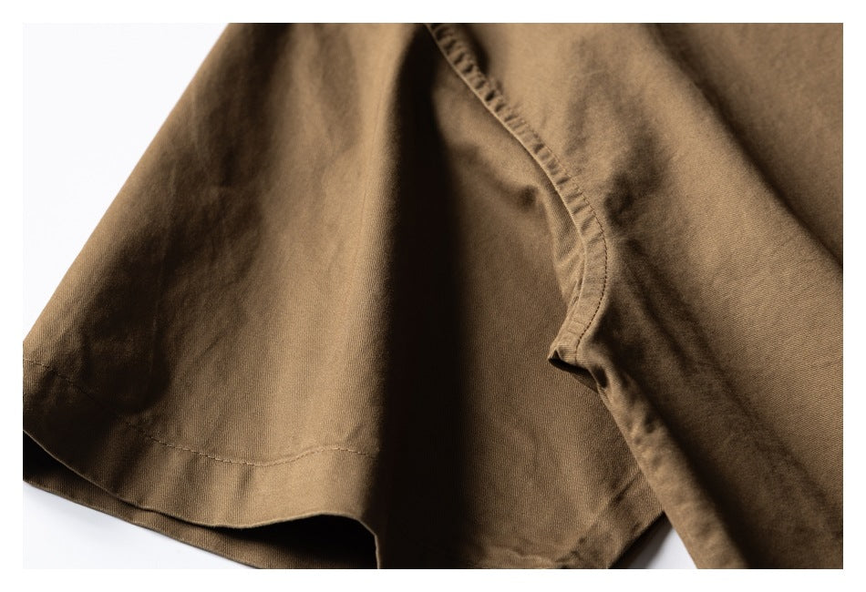 Close-up of a brown shirt sleeve and stitched underarm seam.