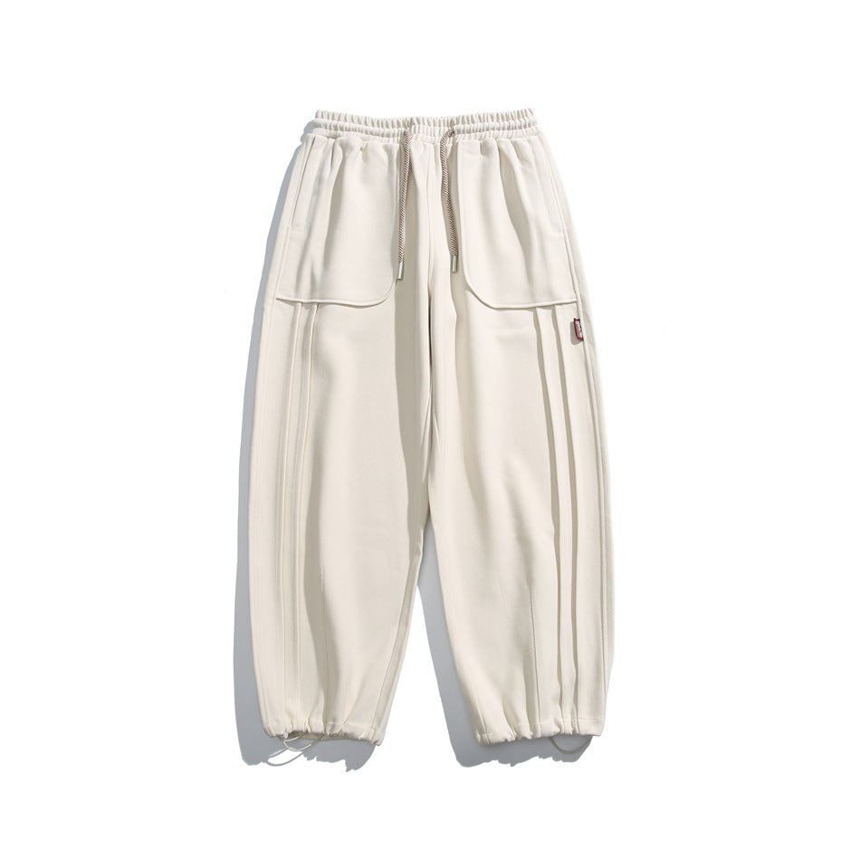 Off-white wide-leg sweatpants flat lay with drawstring waist, front patch pockets and drawstring ankle hems
