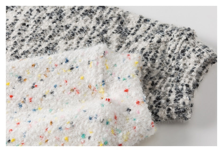 Close-up of colorful flecks in white fuzzy fabric overlapping black-and-white patterned fabric.