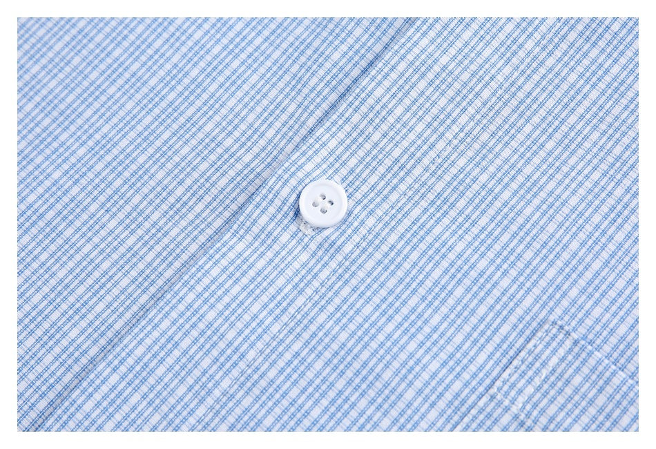 Close-up of blue-and-white checked fabric with a small white four-hole button.