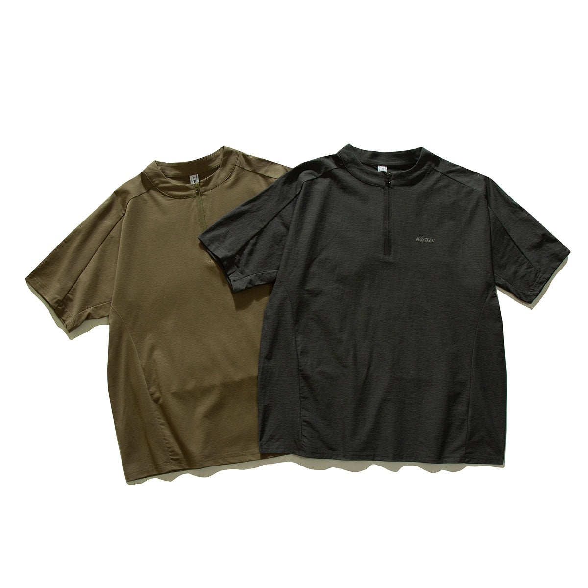 Two short-sleeve quarter-zip shirts shown from the front in olive and charcoal.