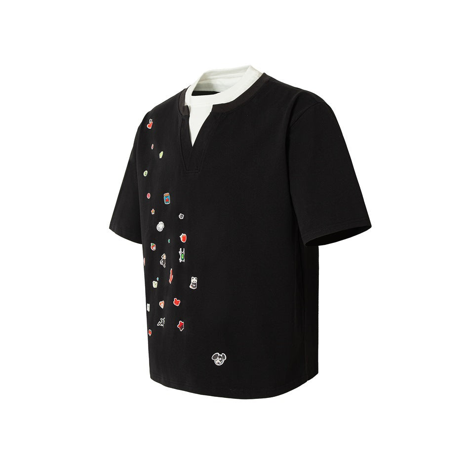 Angled front view of a black short-sleeve shirt with a split neckline, white inset, and small colorful motifs.