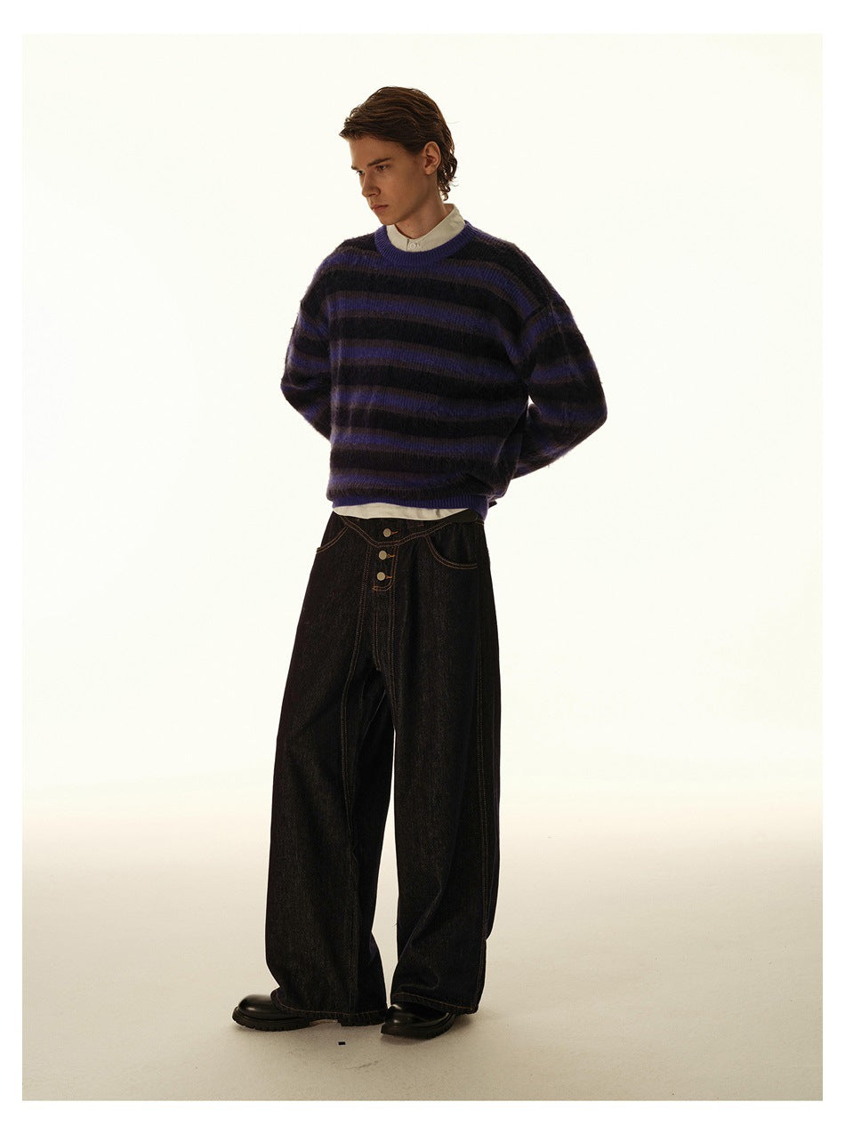 Model wearing a black and purple striped crewneck sweater with dark wide-leg jeans, angled view.