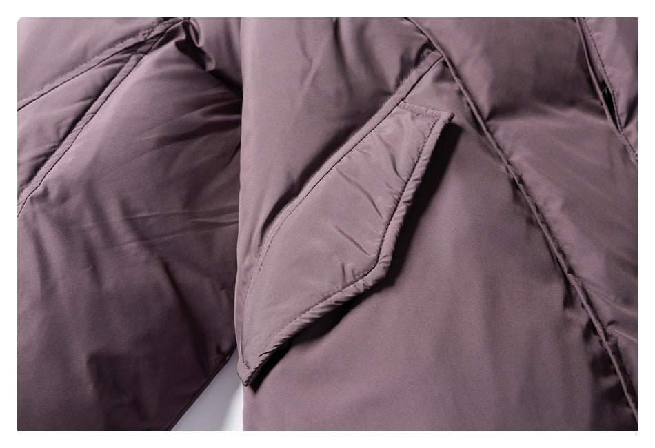 Close-up of a dusty mauve garment showing a large fabric pocket flap and stitched seams.