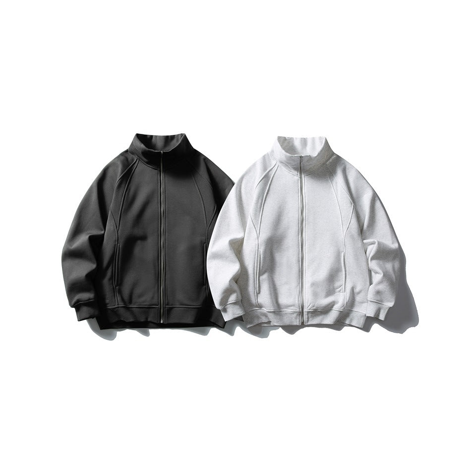 Front view of two zip-up jackets with stand collars, in black and light gray.