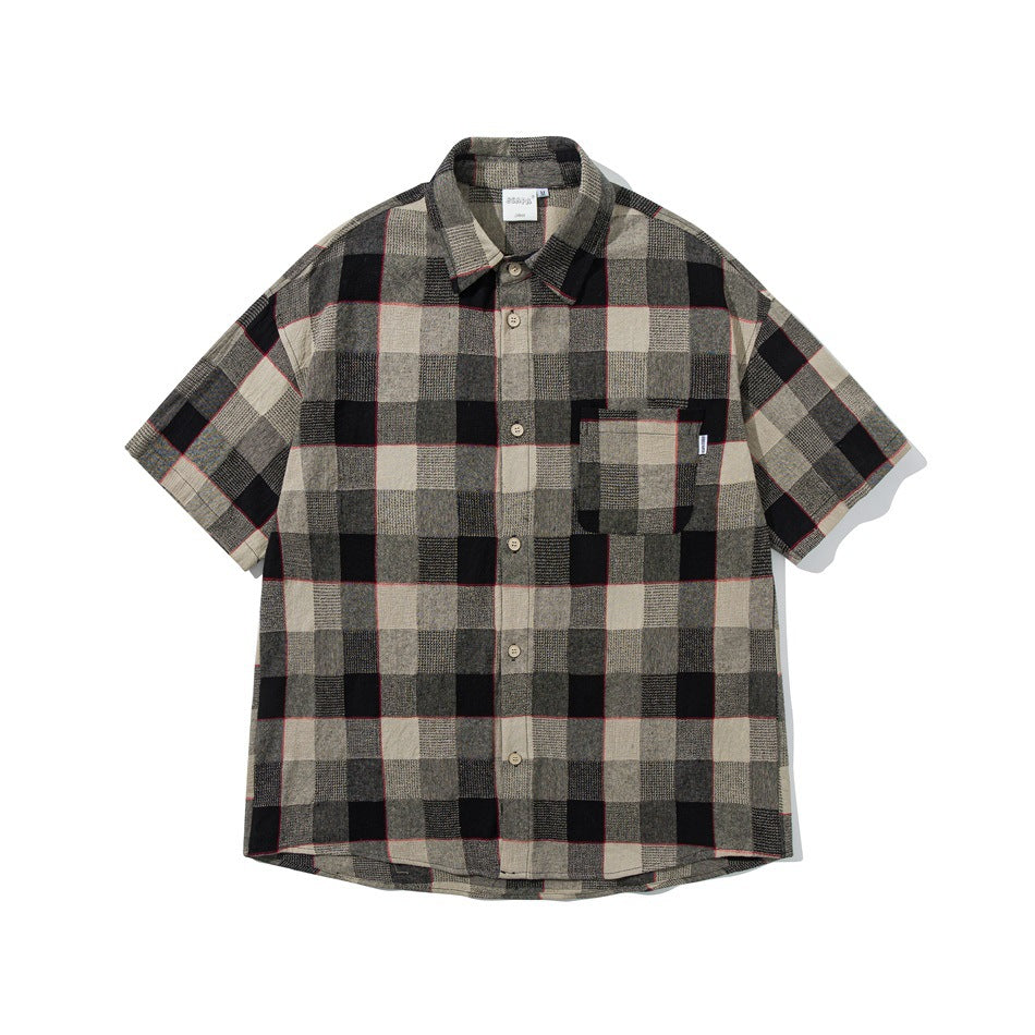 Black and beige plaid short-sleeve button-up shirt with red accent lines, chest pocket, flat front view