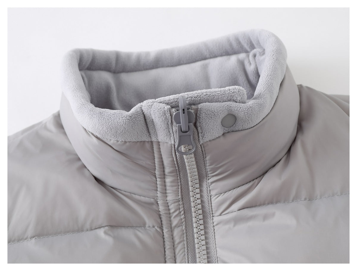 Close-up of the light gray vest's raised fleece-lined collar, front zipper, and snap closure.