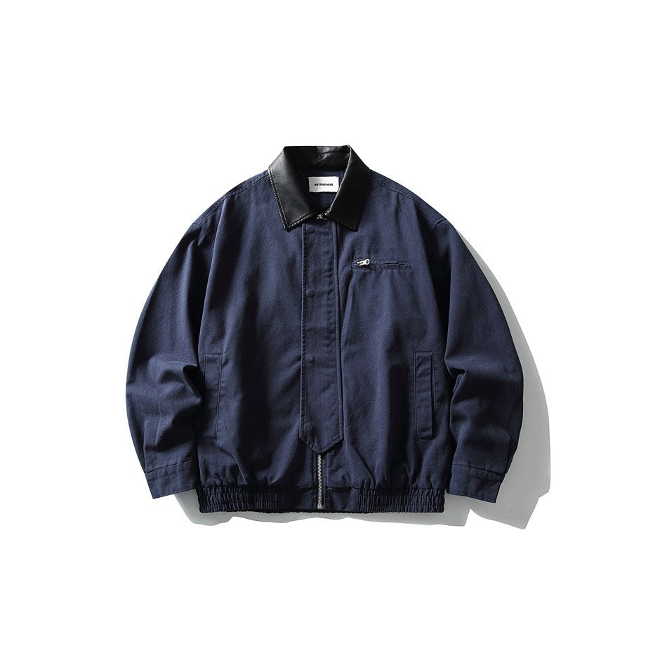 Navy blue collared zip jacket with black faux-leather-look collar, chest zip pocket, side pockets and elastic hem, flat lay