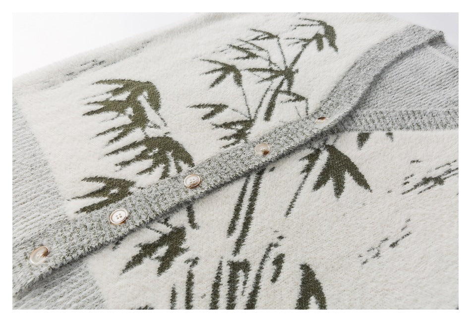 Close-up of the cardigan's gray button placket, pale buttons, fuzzy knit, and dark botanical pattern.
