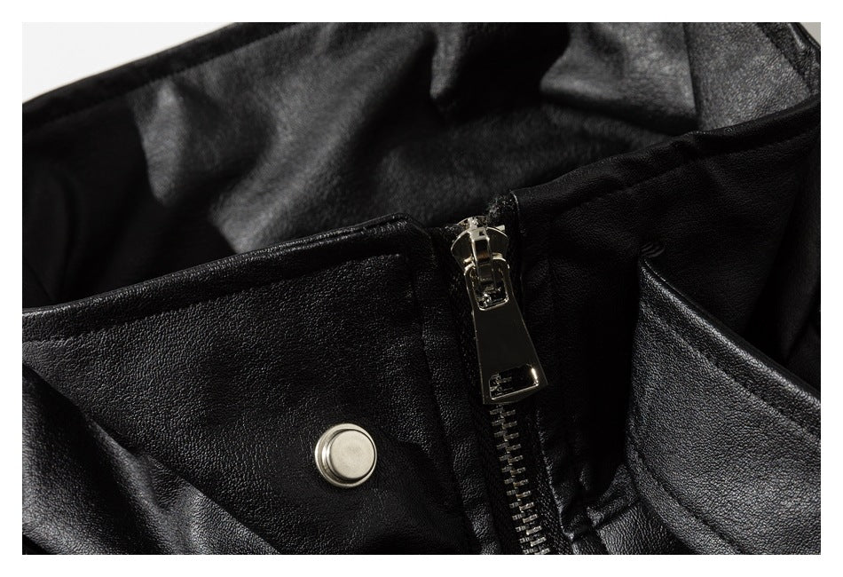 Close-up of the black jacket's front zipper and round snap fastening.