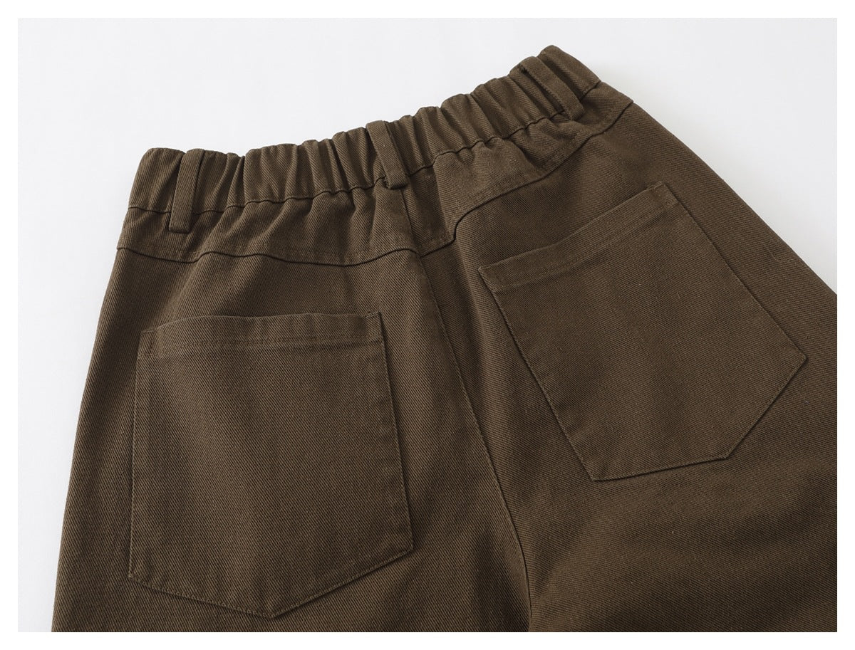 Back view of brown trousers with an elastic waistband and two patch pockets.