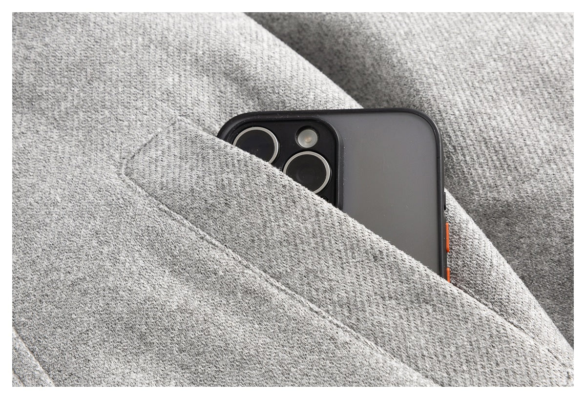 A phone tucked into a pocket in the textured gray coat.