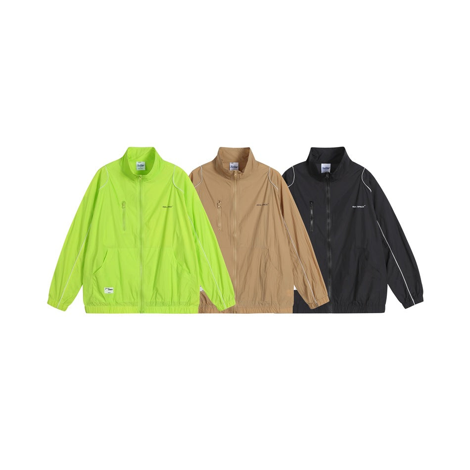 Three front views of the jacket in lime green, tan, and black, each with white piping and a zip front.