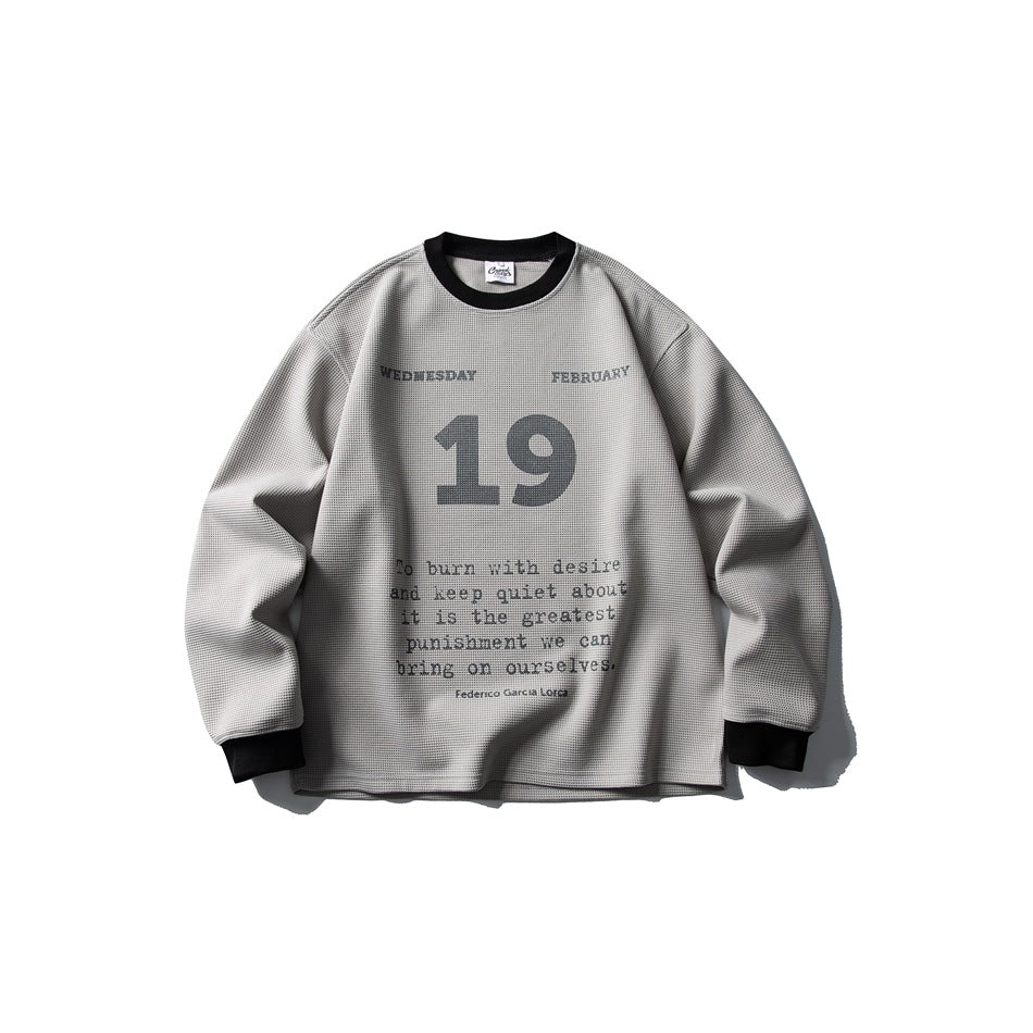 Gray waffle-knit crew neck sweatshirt with black collar and cuffs and a large 19 date print with quote