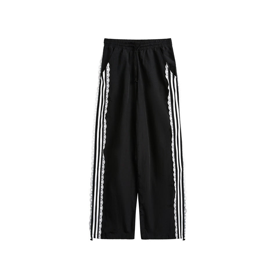 Black wide-leg pants with white three-stripe lace-trimmed side panels and drawstring waist, front flat view