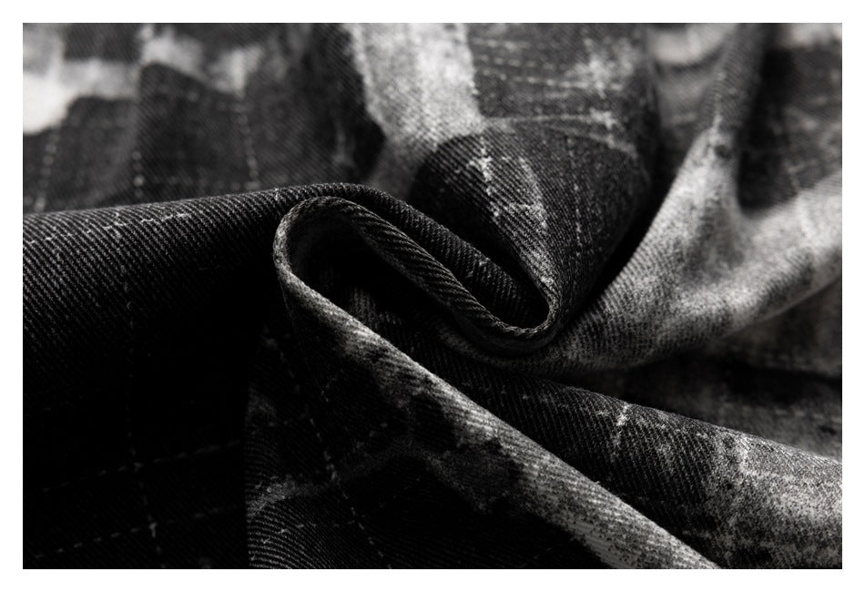 Close-up of black and gray patterned fabric folded to show its textured surface and curled edge.