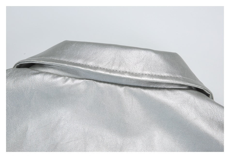 Close-up of a folded silver garment collar or flap with visible stitching.