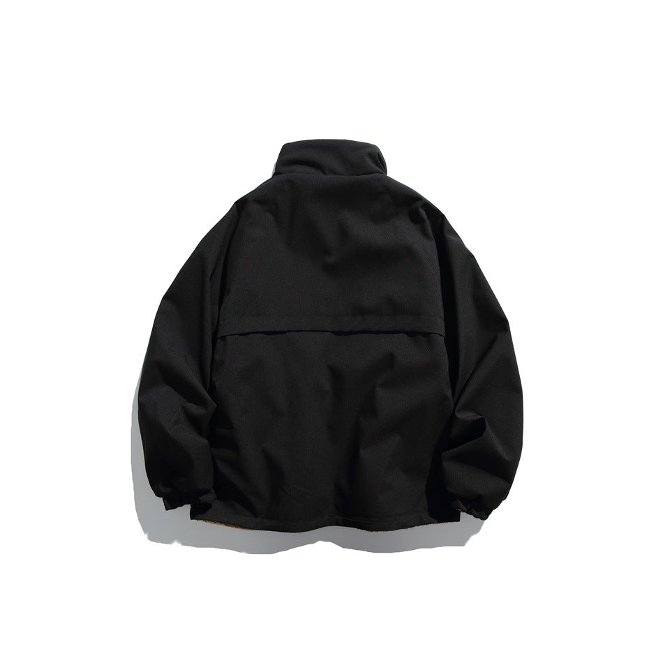 Back view of a black jacket with a stand collar, long sleeves, elastic cuffs, and a horizontal upper-back seam.