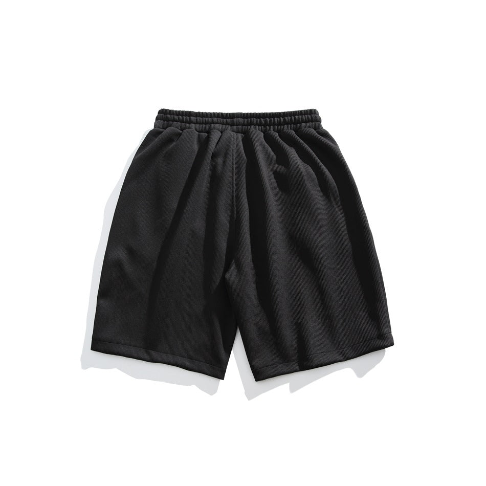 Black shorts shown flat from the front, with an elastic waistband and straight hems.