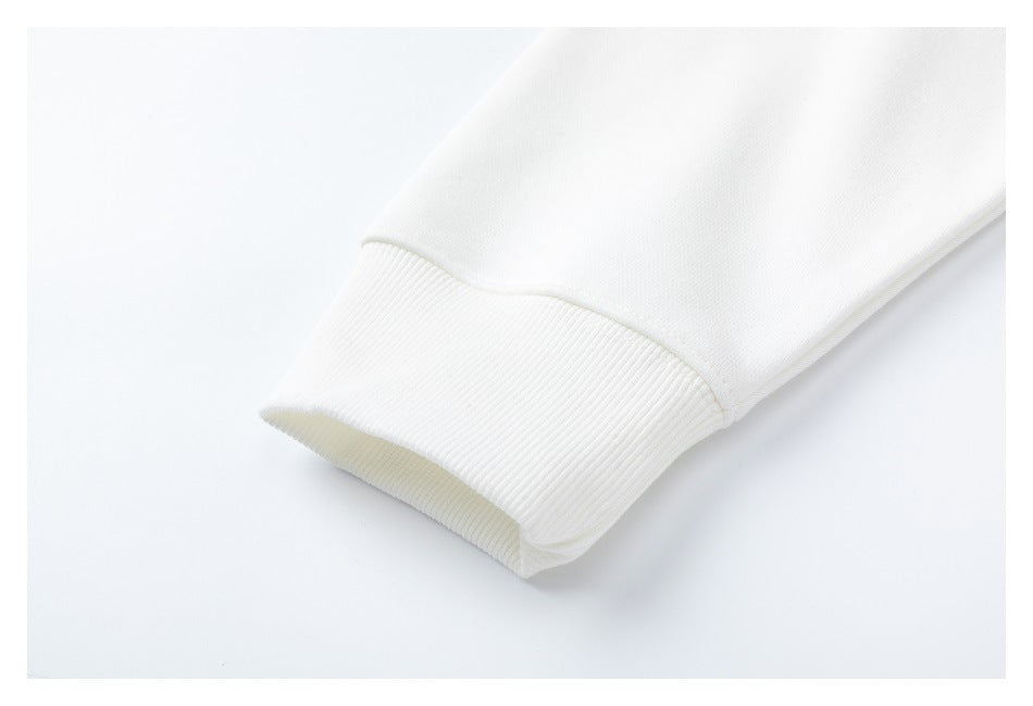 Close-up of a white sweatshirt sleeve ending in a wide ribbed cuff.