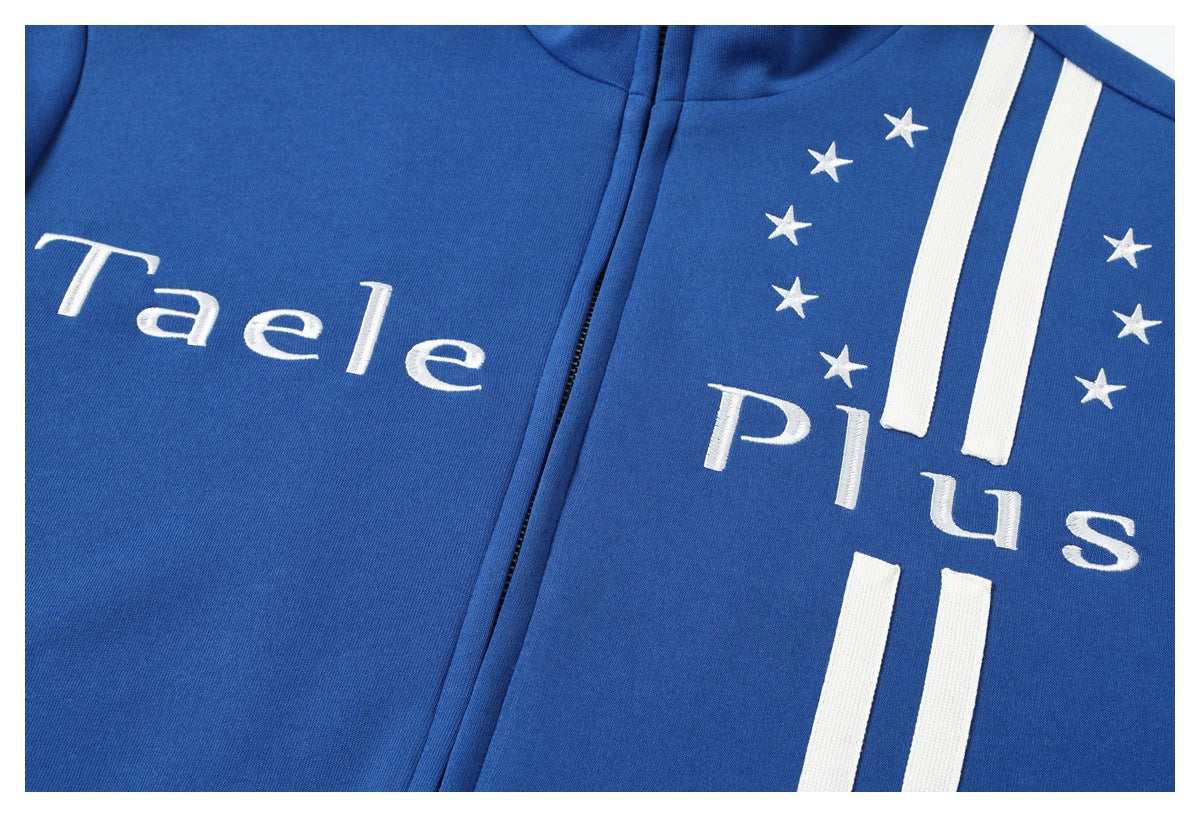 Close-up of a blue zip-up jacket with white “Taele Plus” lettering, stars, and vertical stripes.