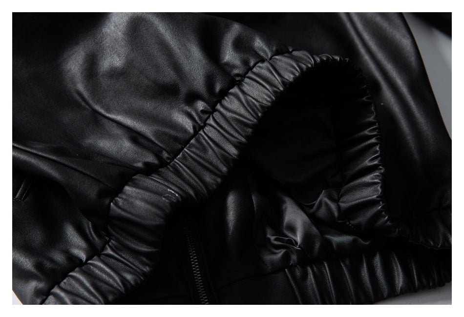 Close-up of a black garment with a gathered elastic edge and a partially visible zipper.