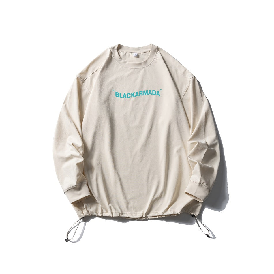 Sand long-sleeve crew-neck top with teal chest text print and drawstring hem, flat lay