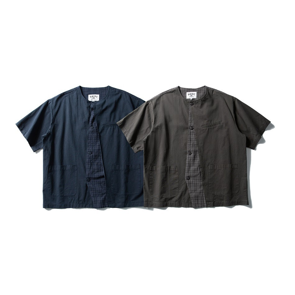 Two short-sleeve collarless shirts in navy and charcoal, with checked plackets and multiple front pockets.