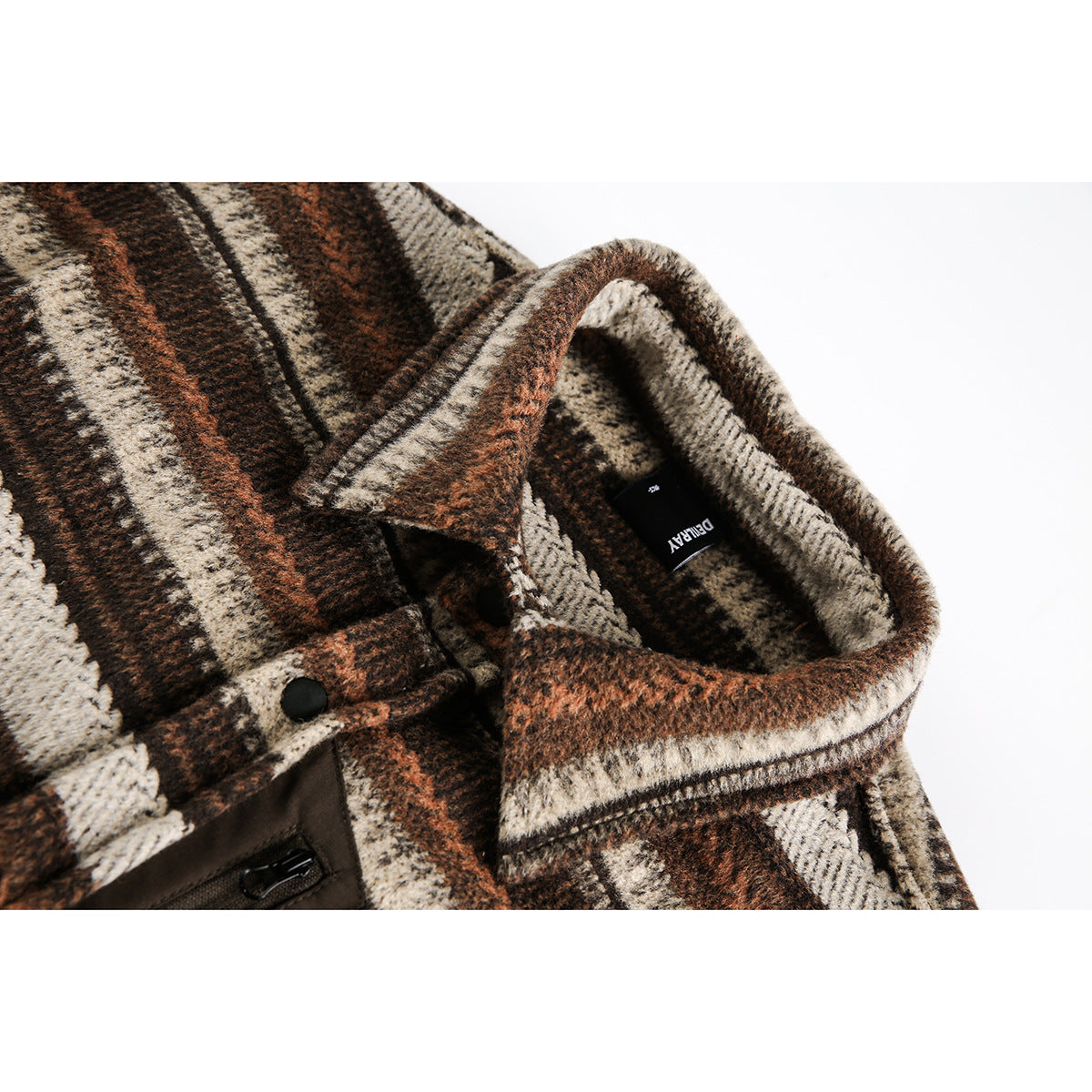Close-up of a brown, cream, and rust plaid overshirt collar, black snap, and inner neck label.