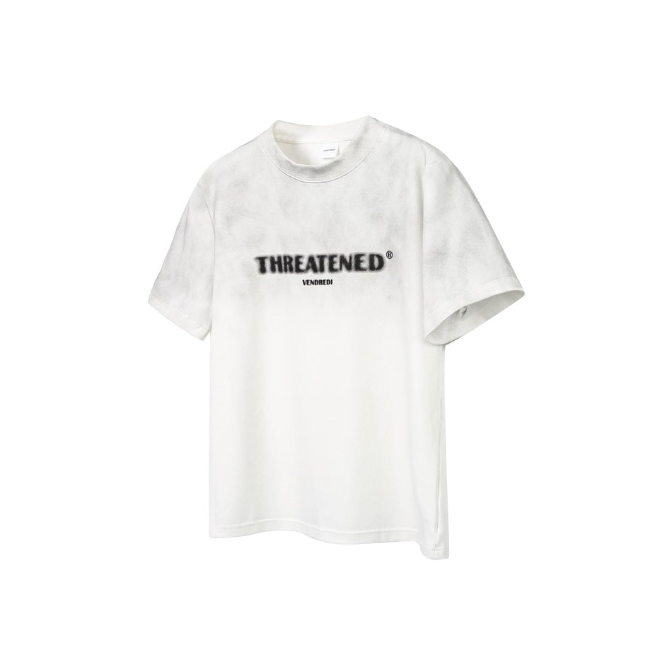 White short-sleeve T-shirt with faded gray wash and blurred black THREATENED chest print, flat front view