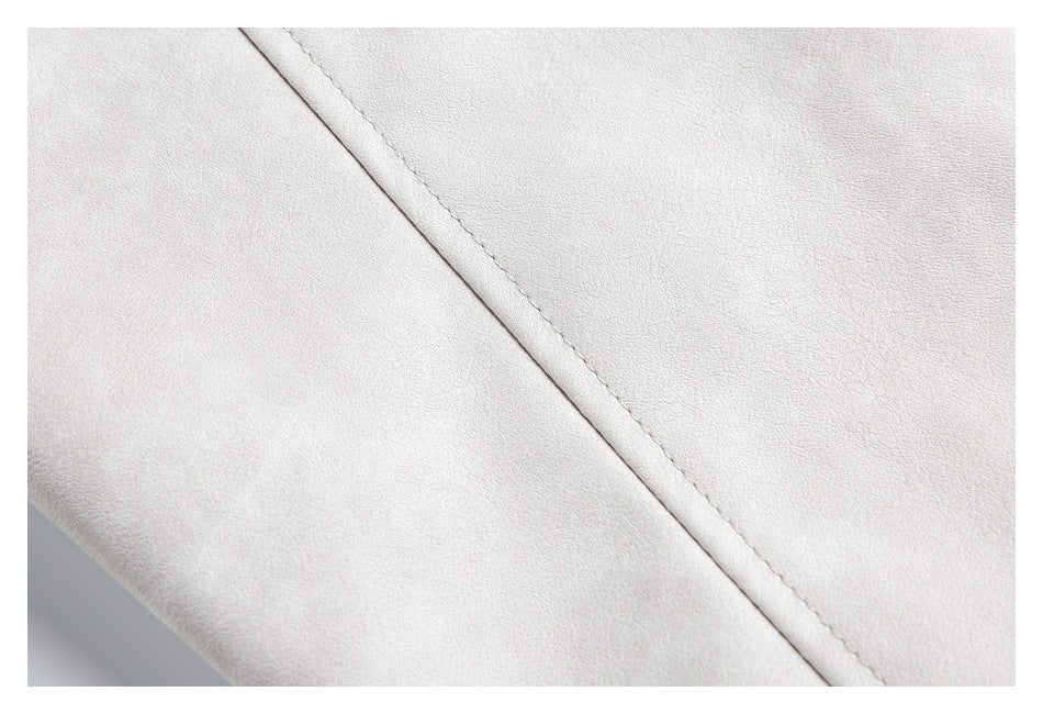 Close-up of a diagonal stitched seam on a pale gray-beige garment.