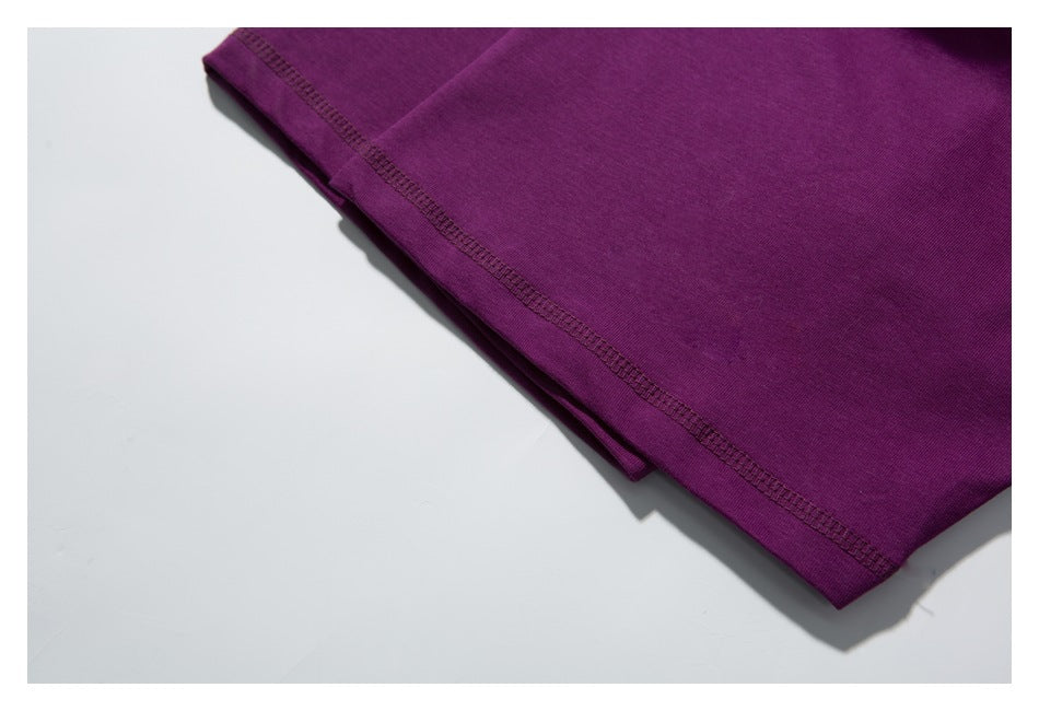 Close-up of the purple shirt's lower edge and stitched hem.
