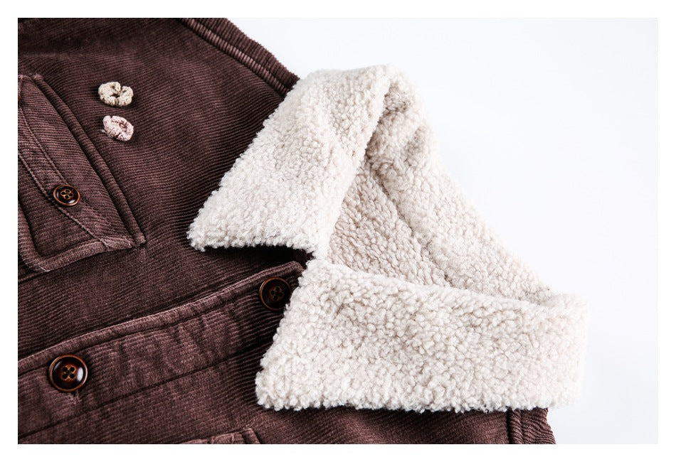 Close-up of the jacket's cream shearling collar and cuff, brown corduroy, buttons, and small flower appliqués.