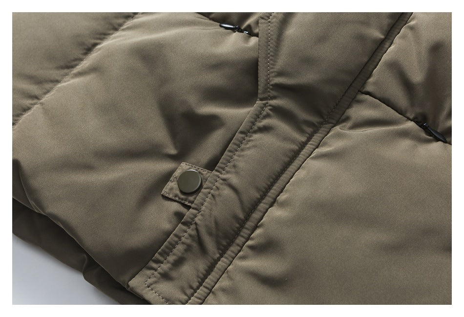 Close-up of a dark snap on the vest's olive-khaki front placket and quilted panels.