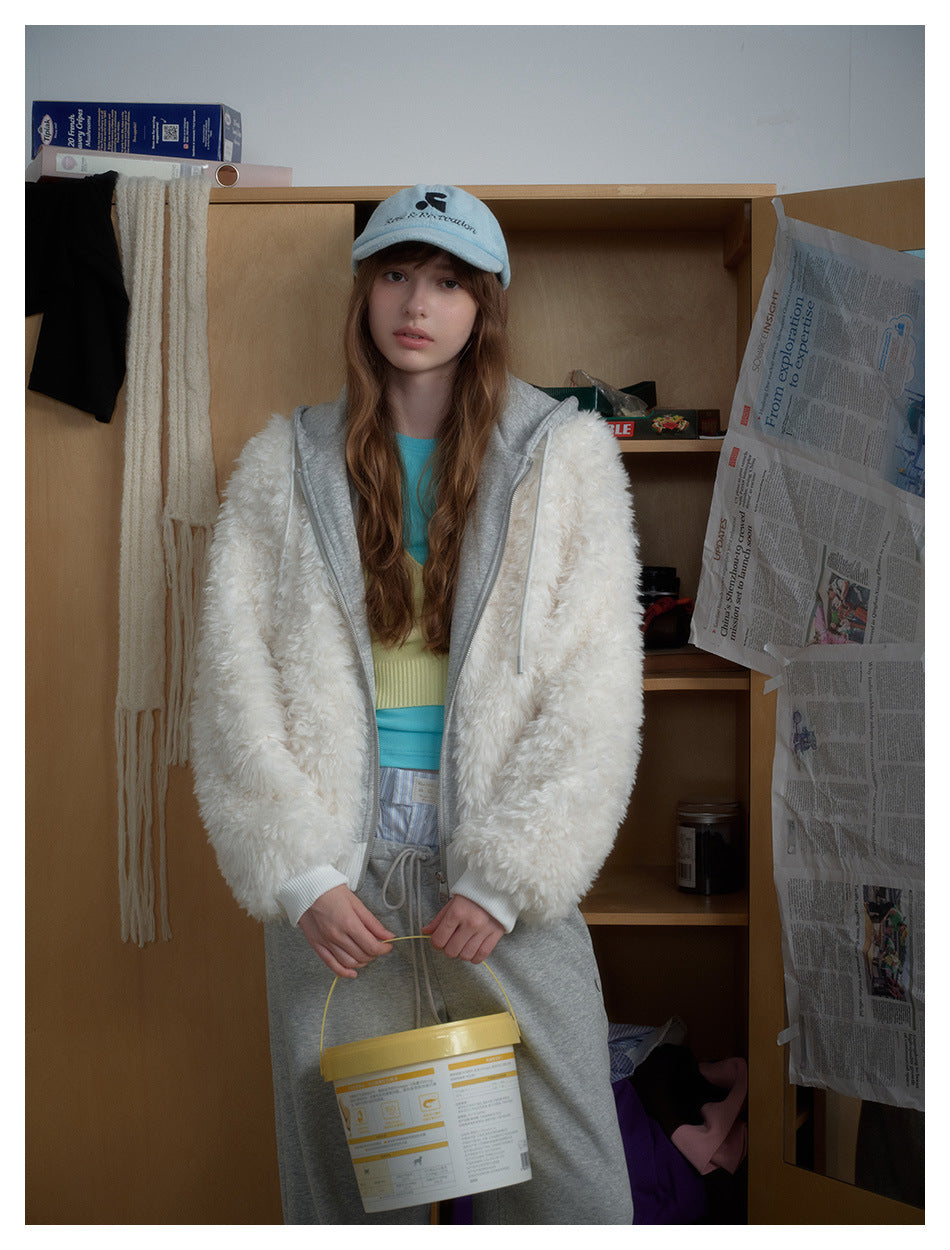 Model in the white fleece-like hooded jacket with gray hood, holding a yellow bucket in front of a wooden wardrobe