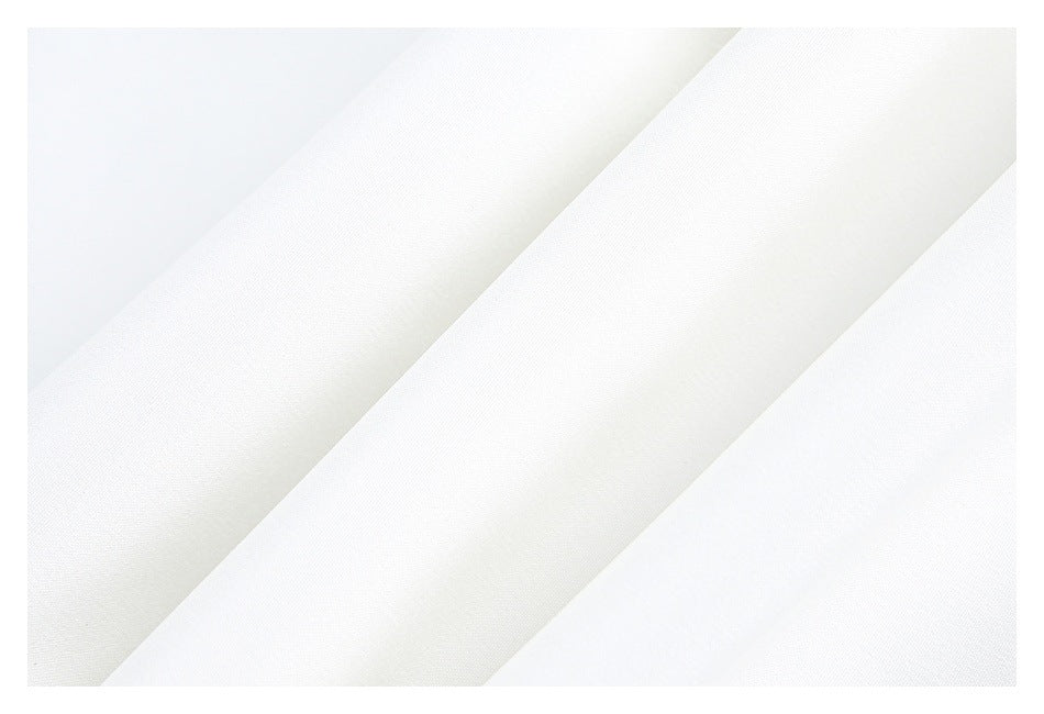 Close-up of smooth white fabric arranged in diagonal folds.