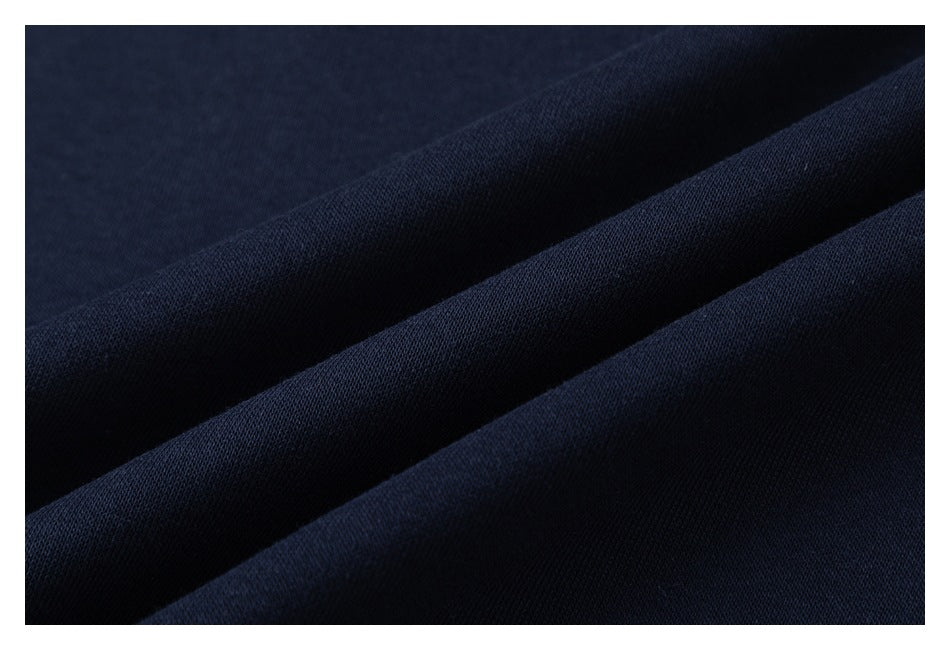 Extreme close-up of navy fabric folded to show its surface and texture.