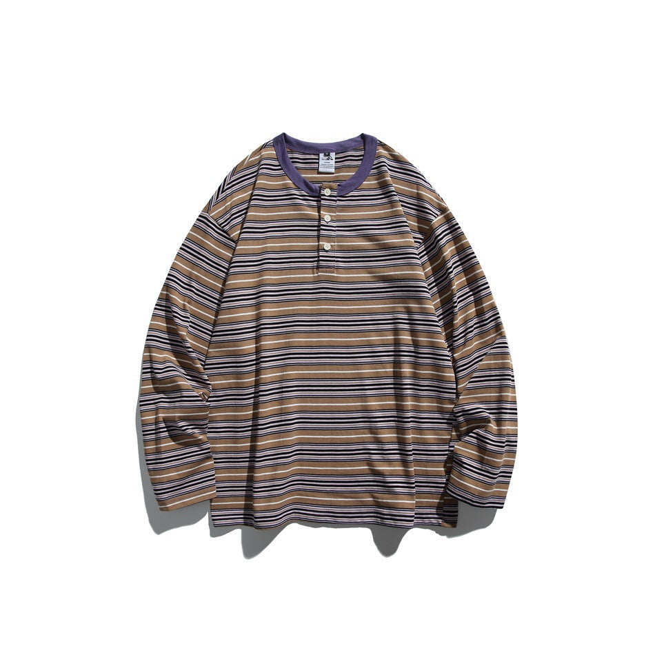 Purple striped long-sleeve top in tan and purple with purple neckline and three-button placket, flat lay