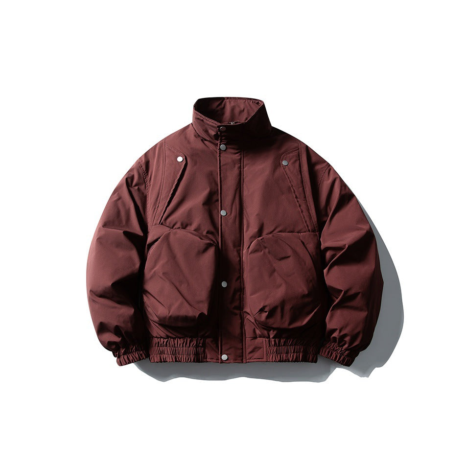 Front view of a burgundy jacket with a high collar, snap front, large flap pockets, and elastic cuffs and hem.