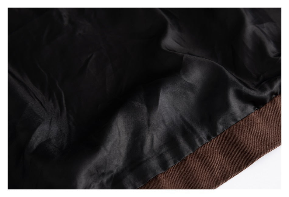 Close-up of the jacket's black inner lining meeting the dark brown outer hem.