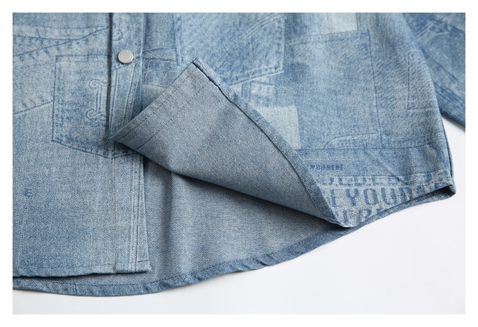 Blue printed denim hem folded back to show its reverse side and stitched edge.